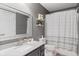Comfortable bathroom featuring a toilet, vanity, shower and mirror with accents of white and gray at 104 Clovis Circle, Myrtle Beach, SC 29579