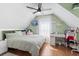 Bedroom with a desk, TV, mounted shelves, a bed, and accents of green at 104 Clovis Circle, Myrtle Beach, SC 29579
