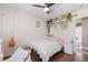 Small bedroom with hardwood floors, a ceiling fan, and a cozy bed with soft-colored pillows at 104 Clovis Circle, Myrtle Beach, SC 29579