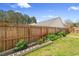Backyard garden area with vegetables, flowers, and wood fence at 104 Clovis Circle, Myrtle Beach, SC 29579