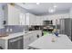 Bright kitchen features stainless steel appliances, white cabinetry, and a stylish backsplash at 104 Clovis Circle, Myrtle Beach, SC 29579