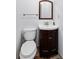 Cozy bathroom features a pedestal sink with a wood vanity, toilet, and neutral wall paint at 1140 Waterway Ln., Myrtle Beach, SC 29572