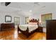 Primary bedroom with hardwood floors, shuttered windows, and traditional decor at 1140 Waterway Ln., Myrtle Beach, SC 29572