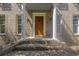 Close-up of the front porch with brick steps, white columns, and a welcoming wood door at 1140 Waterway Ln., Myrtle Beach, SC 29572