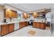 Well-lit kitchen with wood cabinets, stainless steel appliances, and white countertops at 1140 Waterway Ln., Myrtle Beach, SC 29572