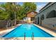 Inviting in-ground pool with a patio, complemented by palm trees and lush greenery, offering a private retreat at 1140 Waterway Ln., Myrtle Beach, SC 29572