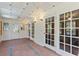 Bright sun room with tile flooring, multiple glass doors, and recessed lighting at 1140 Waterway Ln., Myrtle Beach, SC 29572