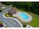 Aerial view of community pool, clubhouse, landscaping, and parking at 115 Machrie Loop # D, Myrtle Beach, SC 29588