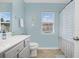 Bathroom featuring blue walls, white fixtures, and natural light from a window at 115 Machrie Loop # D, Myrtle Beach, SC 29588