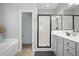 Bright bathroom featuring a soaking tub, glass-enclosed shower, and neutral color scheme at 115 Machrie Loop # D, Myrtle Beach, SC 29588