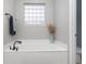 Bathroom showcasing a large soaking tub and natural light from a glass block window at 115 Machrie Loop # D, Myrtle Beach, SC 29588