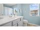 Bathroom featuring blue walls, white fixtures, and natural light from a window at 115 Machrie Loop # D, Myrtle Beach, SC 29588