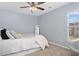 Comfortable bedroom features a ceiling fan and natural light from a window at 115 Machrie Loop # D, Myrtle Beach, SC 29588