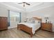 Serene bedroom with tray ceilings, wood flooring, and a large window with natural light at 115 Machrie Loop # D, Myrtle Beach, SC 29588