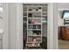 Brightly lit closet featuring shelves with neatly folded clothes, bags, and shoes at 115 Machrie Loop # D, Myrtle Beach, SC 29588