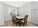 Cozy dining room with a chandelier, natural light, and seating for six guests at 115 Machrie Loop # D, Myrtle Beach, SC 29588