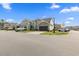 Street view of homes with matching architecture, landscaping, and attached garages at 115 Machrie Loop # D, Myrtle Beach, SC 29588