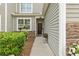 Inviting front porch with stone accents, lush greenery, and decorative flower baskets at 115 Machrie Loop # D, Myrtle Beach, SC 29588