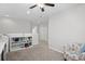 Versatile loft space with neutral walls, carpet, ceiling fan, and custom storage shelves at 115 Machrie Loop # D, Myrtle Beach, SC 29588