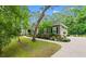 Charming one-story home with manicured landscaping, walkway, driveway, and attached garage surrounded by mature trees at 116 Chapel Ridge Circle, Myrtle Beach, SC 29588
