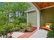 Charming house exterior featuring an inviting porch with brick, a wooden bench, and lush greenery at 116 Chapel Ridge Circle, Myrtle Beach, SC 29588