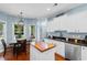 Well-lit kitchen showcases stainless steel appliances, white cabinets, and a cozy dining area at 116 Chapel Ridge Circle, Myrtle Beach, SC 29588