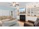 Cozy living room with a decorative fireplace, built-in shelving, comfortable seating, and ceiling fan at 116 Chapel Ridge Circle, Myrtle Beach, SC 29588