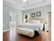 Bright main bedroom features a tray ceiling, neutral paint, and a view of the ensuite bath at 116 Chapel Ridge Circle, Myrtle Beach, SC 29588