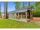 Exterior view of shed with deck and porch in a well-manicured, green backyard at 116 Chapel Ridge Circle, Myrtle Beach, SC 29588