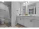 This bright bathroom features double sinks, lots of counter space, and a shower-tub combo at 1168 Baker Creek Loop, Myrtle Beach, SC 29579