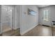 Bright entryway with stylish flooring, leading to a bathroom and an exit to the outdoors at 1168 Baker Creek Loop, Myrtle Beach, SC 29579