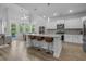 Open kitchen with a center island, pendant lighting, and stainless steel appliances flowing into the living area at 1168 Baker Creek Loop, Myrtle Beach, SC 29579