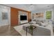 Stylish living room features a large sectional sofa, wood accent wall, and modern decor at 1168 Baker Creek Loop, Myrtle Beach, SC 29579