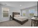 This main bedroom features a plush bed, soft carpet, and bright windows at 1168 Baker Creek Loop, Myrtle Beach, SC 29579