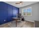 A home office showcases a striking blue accent wall, providing a professional workspace at 1168 Baker Creek Loop, Myrtle Beach, SC 29579