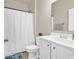 Clean bathroom featuring a white vanity, matching toilet, and shower with white curtain at 1170 Maxwell Dr., Little River, SC 29566
