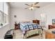 Cozy bedroom with wood-look floors, ceiling fan and ensuite bathroom access at 1170 Maxwell Dr., Little River, SC 29566
