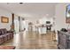 Open-concept living room showcasing hardwood flooring, stylish furnishings, and seamless access to the kitchen at 1170 Maxwell Dr., Little River, SC 29566