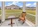 Inviting screened porch with rocking chair and outdoor views of the community at 1170 Maxwell Dr., Little River, SC 29566