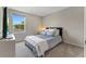 Comfortable bedroom features a plush bed, soft carpet, and a window that offers lots of natural light at 120 Carolina Lakes Blvd., Myrtle Beach, SC 29588