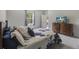 Cozy bedroom with ample natural light, comfortable bedding, and a modern entertainment setup at 120 Carolina Lakes Blvd., Myrtle Beach, SC 29588