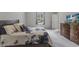 Bright bedroom featuring a floral bedspread, modern curtains, and a wall-mounted TV at 120 Carolina Lakes Blvd., Myrtle Beach, SC 29588