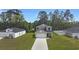 Charming two-story home featuring a well-manicured lawn and a concrete driveway leading to an attached garage at 120 Carolina Lakes Blvd., Myrtle Beach, SC 29588