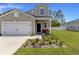 Charming home with a well-manicured lawn, colorful flowerbeds, and a cozy front porch at 120 Carolina Lakes Blvd., Myrtle Beach, SC 29588