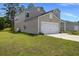 Side view of a home highlighting the attached two-car garage and manicured lawn at 120 Carolina Lakes Blvd., Myrtle Beach, SC 29588