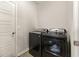 Functional laundry room equipped with side-by-side appliances and a convenient doorway at 120 Carolina Lakes Blvd., Myrtle Beach, SC 29588