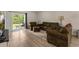 This is a large living room with sliding glass door to the backyard and comfortable seating at 120 Carolina Lakes Blvd., Myrtle Beach, SC 29588