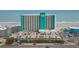 Aerial shot of oceanfront building with parking deck, beach access, and ocean views at 1210 N Waccamaw Dr. # 1105, Murrells Inlet, SC 29576