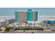 Aerial shot of oceanfront building with parking deck, beach access, and ocean views at 1210 N Waccamaw Dr. # 1105, Murrells Inlet, SC 29576