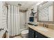 Well-lit bathroom with a shower and tub combination, featuring a stylish vanity and decorative wallpaper at 1210 N Waccamaw Dr. # 1105, Murrells Inlet, SC 29576